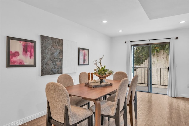 dining space with recessed lighting, baseboards, and light wood finished floors