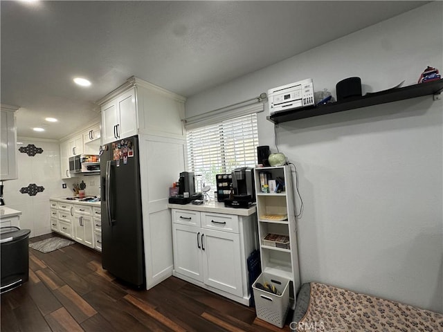 323 E 107th St, Los Angeles, CA 90003 - kitchen with black appliances, light countertops, white cabinets, dark wood-type flooring, and recessed lighting