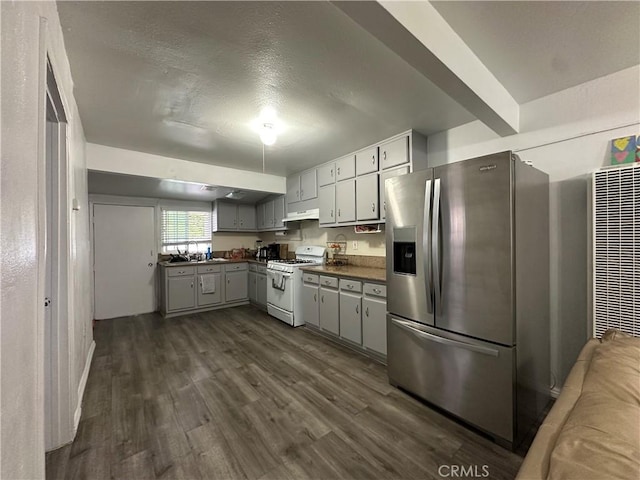 323 E 107th St, Los Angeles, CA 90003 - kitchen with stainless steel refrigerator with ice dispenser, dark countertops, a sink, white range with gas cooktop, and dark wood-style flooring