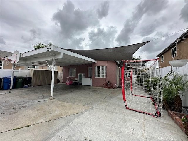 323 E 107th St, Los Angeles, CA 90003 - exterior space with fence, a carport, and stucco siding