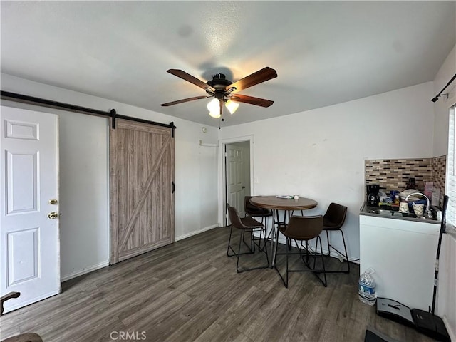 323 E 107th St, Los Angeles, CA 90003 - dining space with a barn door, baseboards, a ceiling fan, and wood finished floors
