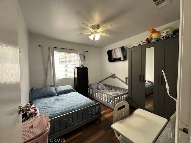 323 E 107th St, Los Angeles, CA 90003 - bedroom featuring dark wood-type flooring, visible vents, and a ceiling fan