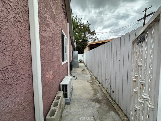 323 E 107th St, Los Angeles, CA 90003 - view of home's exterior featuring fence, ac unit, and stucco siding
