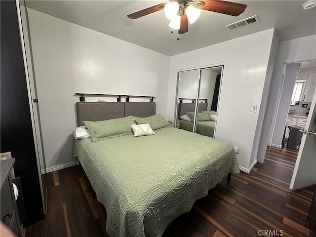 323 E 107th St, Los Angeles, CA 90003 - bedroom with baseboards, wood finished floors, visible vents, and a closet