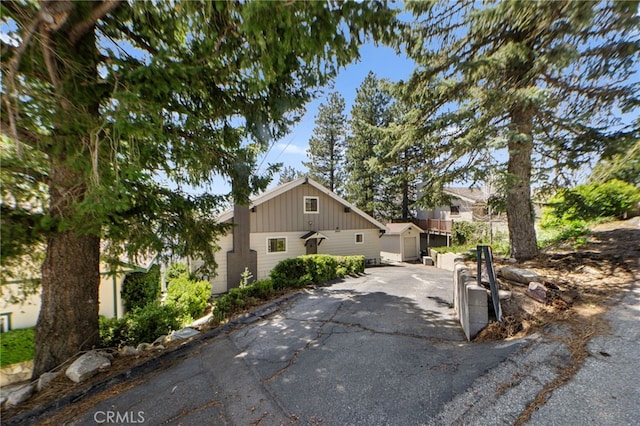 view of front of house featuring an outbuilding and aphalt driveway