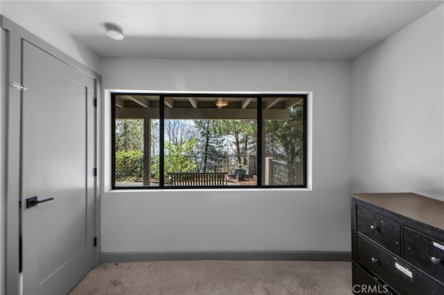 unfurnished bedroom featuring a closet, carpet flooring, and baseboards