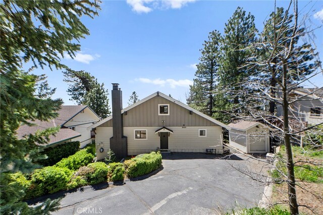 26429 Apache Trl, Rimforest, CA 92378 - view of front of property with a chimney and board and batten siding