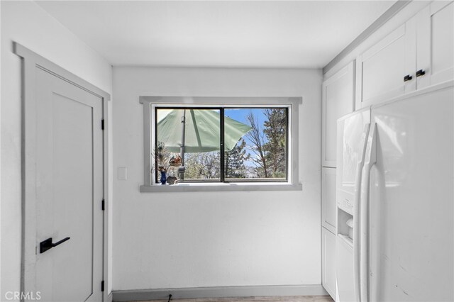 26429 Apache Trl, Rimforest, CA 92378 - kitchen with white refrigerator with ice dispenser and white cabinetry