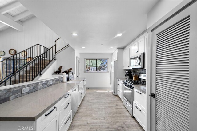 26429 Apache Trl, Rimforest, CA 92378 - kitchen featuring appliances with stainless steel finishes, light wood-style flooring, recessed lighting, white cabinets, and backsplash
