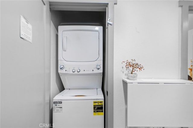 laundry area featuring stacked washing maching and dryer and laundry area
