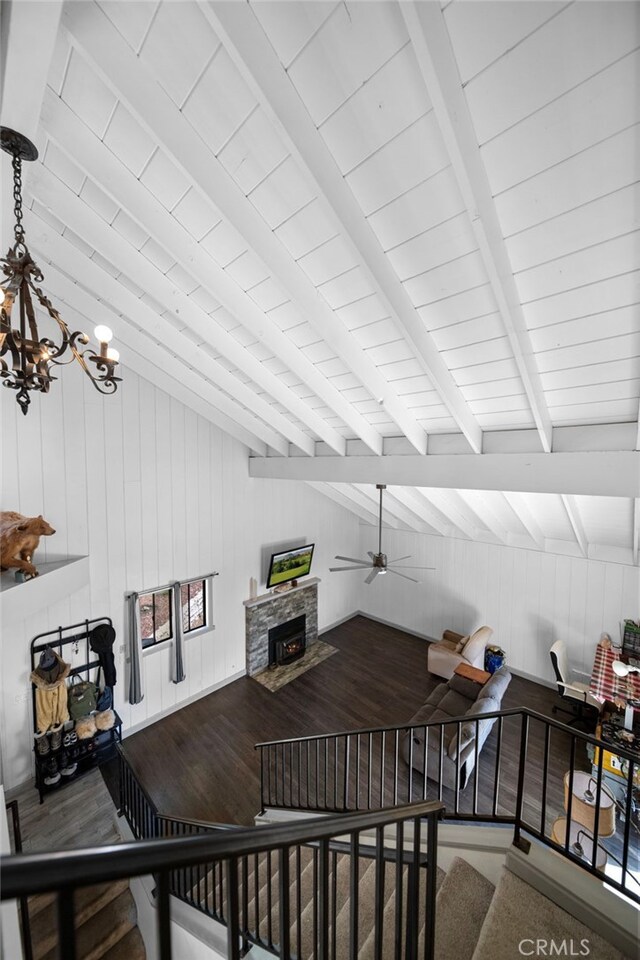26429 Apache Trl, Rimforest, CA 92378 - living area with a ceiling fan, a chandelier, a fireplace, wood finished floors, and wooden walls