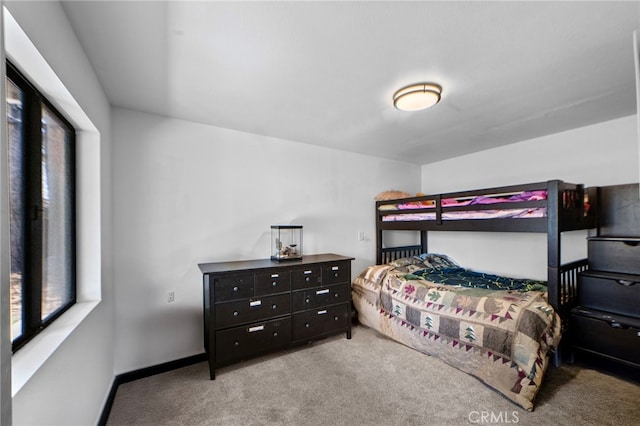bedroom with carpet flooring and baseboards