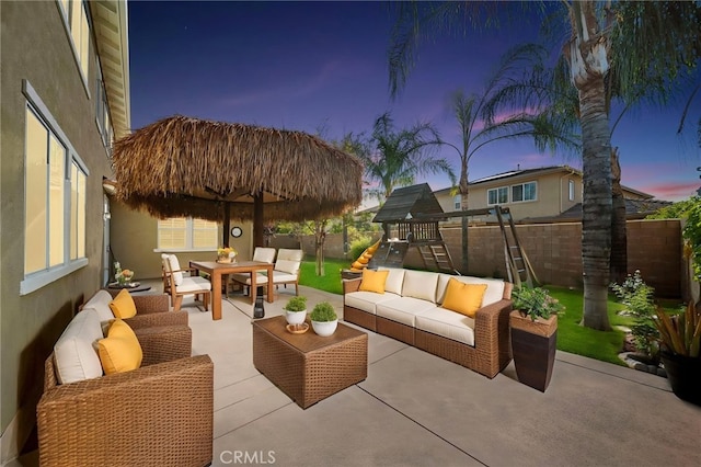 view of patio featuring an outdoor hangout area, a fenced backyard, outdoor dining area, and a playground