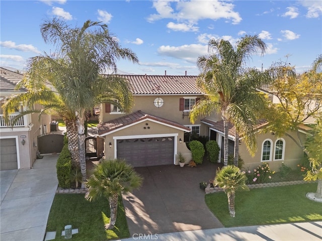 mediterranean / spanish-style house featuring a tile roof, a front lawn, a garage, concrete driveway, and stucco siding