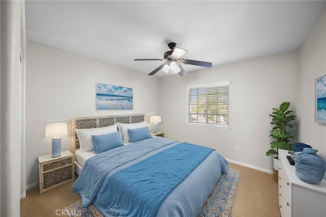 bedroom with ceiling fan, carpet, and baseboards