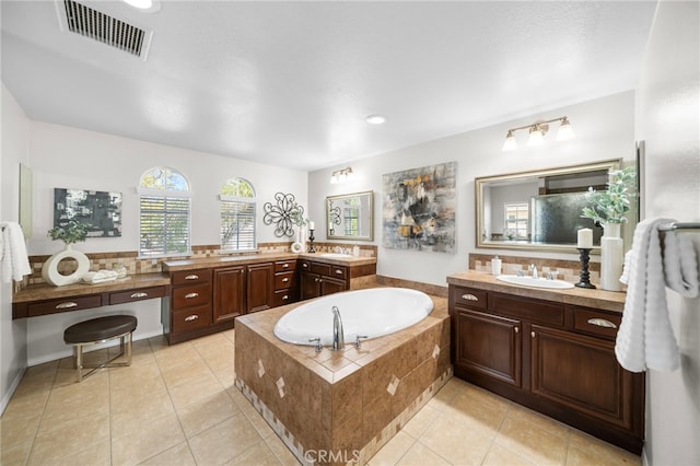 bathroom with a sink, visible vents, two vanities, a garden tub, and tile patterned flooring