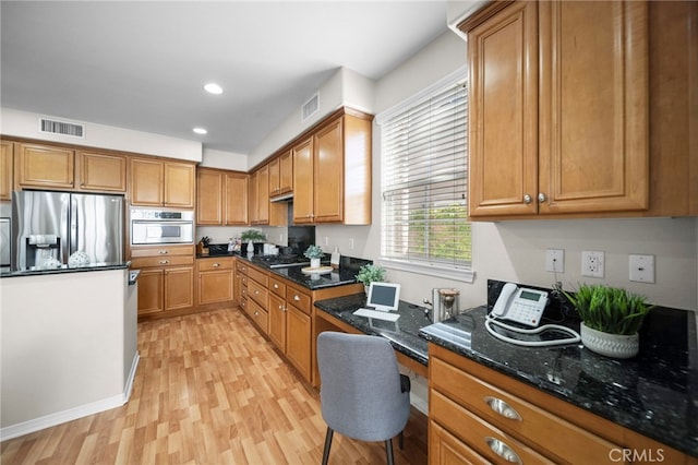 kitchen with visible vents, stainless steel appliances, light wood-type flooring, and built in study area