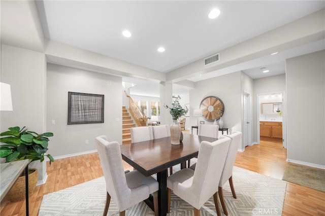 dining area featuring recessed lighting, light wood-style flooring, stairway, baseboards, and visible vents