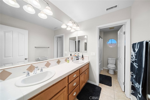 full bathroom with toilet, a sink, tile patterned floors, and visible vents