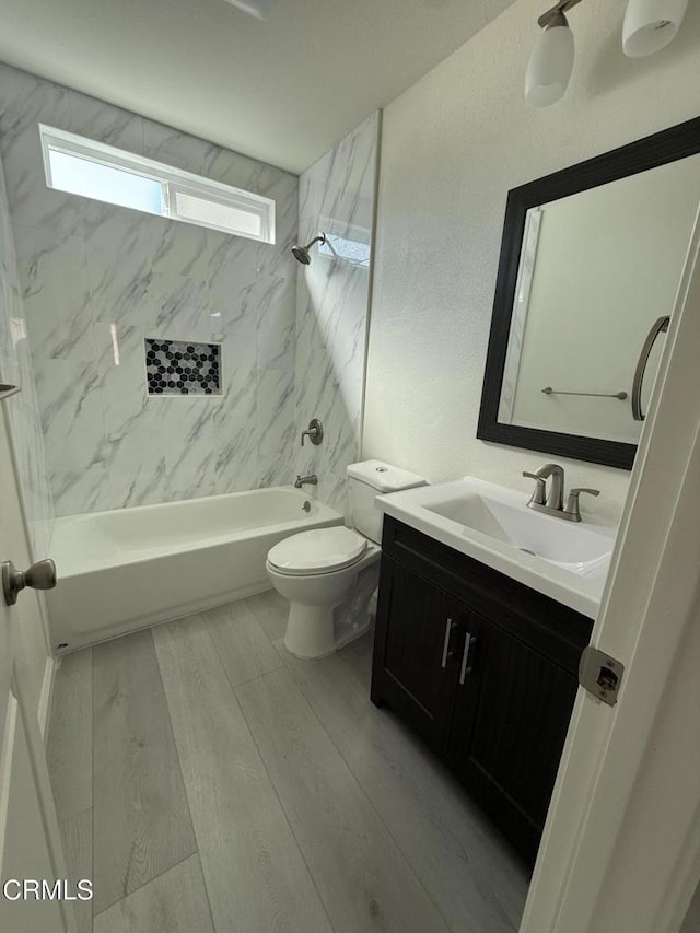 full bathroom with toilet, shower / tub combination, wood finished floors, and vanity