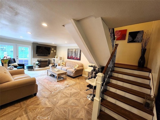 living room with a textured ceiling, stairs, recessed lighting, baseboards, and ornamental molding