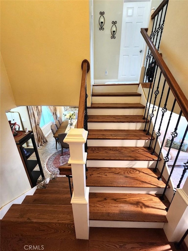 staircase with wood finished floors