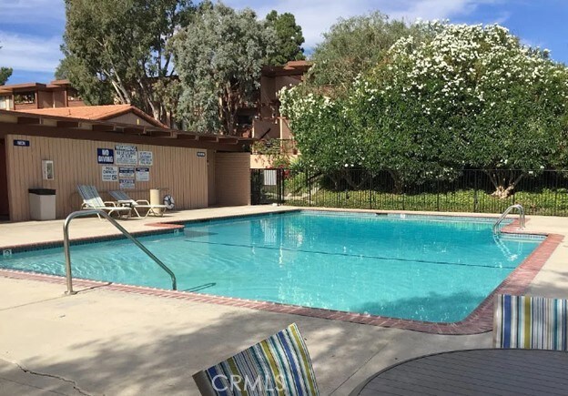 pool featuring fence and a patio