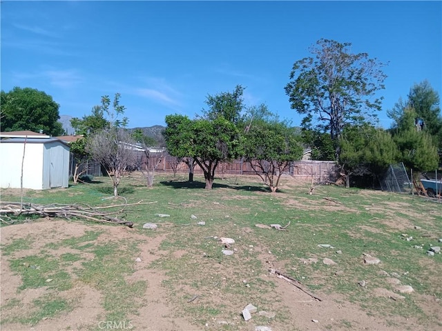12055 Douglas St, Yucaipa, CA 92399 - view of yard featuring fence, an outdoor structure, and a shed