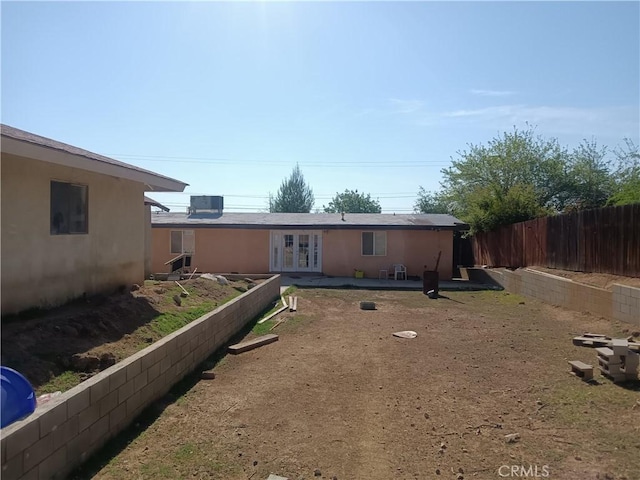 12055 Douglas St, Yucaipa, CA 92399 - back of property with fence, a patio, french doors, and stucco siding