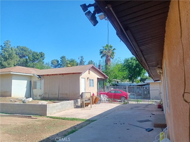 12055 Douglas St, Yucaipa, CA 92399 - view of side of property with fence and a patio