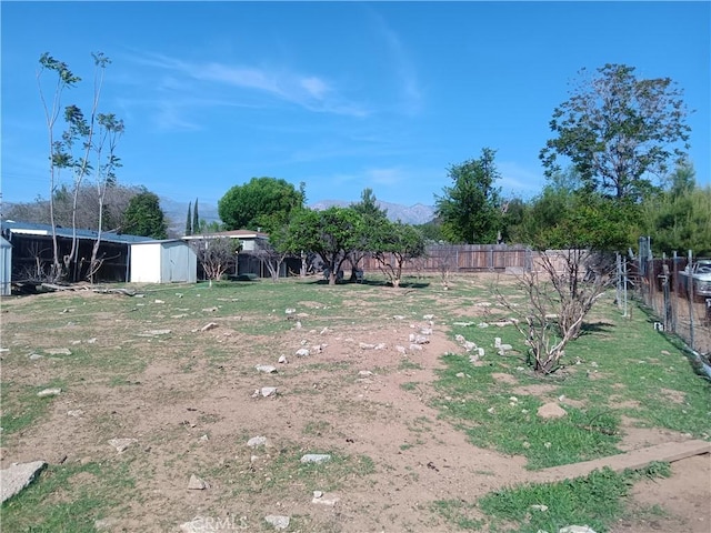 12055 Douglas St, Yucaipa, CA 92399 - view of yard featuring a fenced backyard, an outbuilding, and a storage shed
