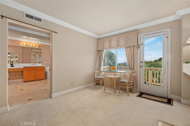 interior space with baseboards, visible vents, light carpet, and crown molding