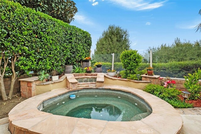 view of swimming pool featuring an in ground hot tub