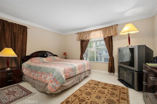 carpeted bedroom with ornamental molding