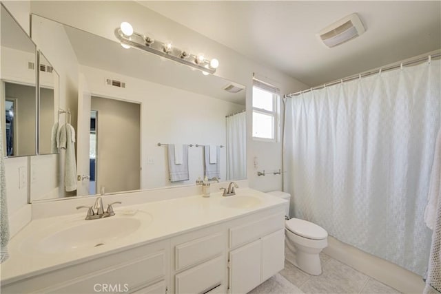32851 Naples Ct, Temecula, CA 92592 - bathroom with toilet, double vanity, a sink, and tile patterned floors