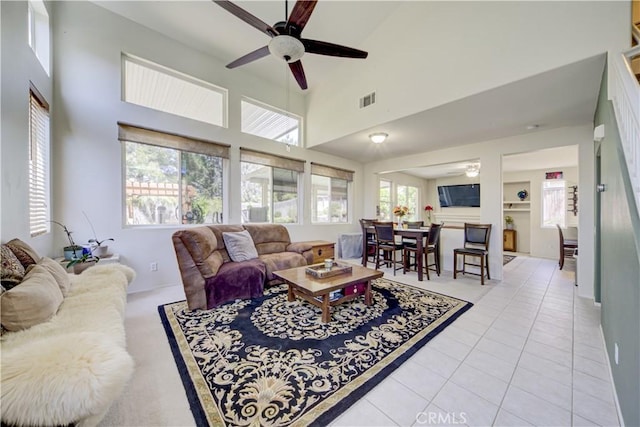 32851 Naples Ct, Temecula, CA 92592 - living room with visible vents, light tile patterned floors, a ceiling fan, and a towering ceiling