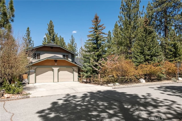 view of front of property with concrete driveway and a garage