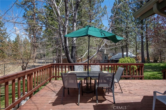 wooden terrace with outdoor dining area