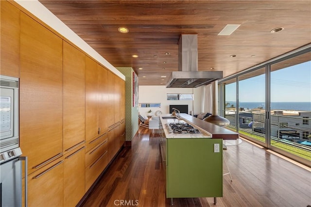 kitchen with stainless steel gas cooktop, wood ceiling, island exhaust hood, dark wood-style floors, and a center island