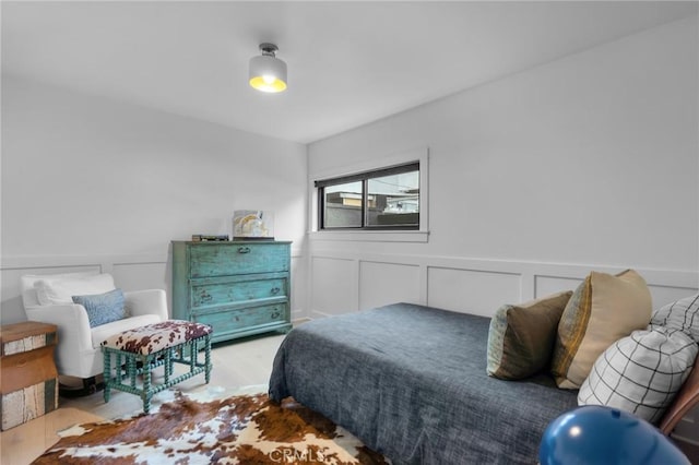 1012 10th St, Manhattan Beach, CA 90266 - bedroom with wainscoting, a decorative wall, and wood finished floors