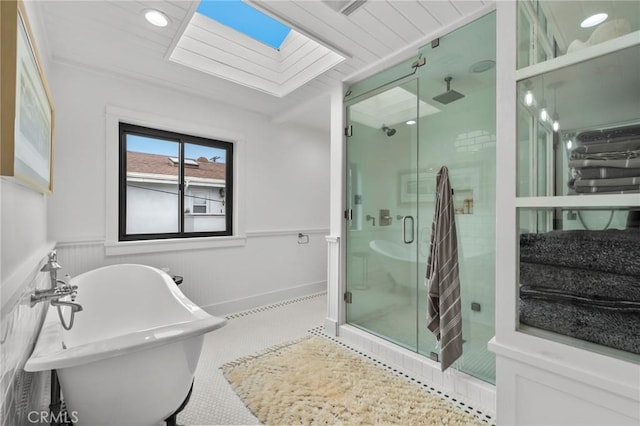 1012 10th St, Manhattan Beach, CA 90266 - bathroom featuring a skylight, a wainscoted wall, a stall shower, and a freestanding tub