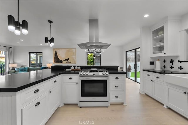 1012 10th St, Manhattan Beach, CA 90266 - kitchen featuring gas stove, dark countertops, island exhaust hood, and a chandelier