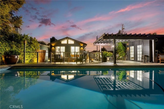 1012 10th St, Manhattan Beach, CA 90266 - pool at dusk with a pergola, a patio, and an outdoor pool