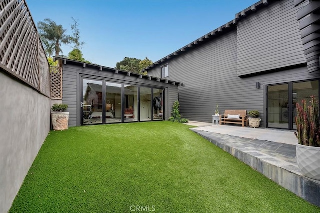 1012 10th St, Manhattan Beach, CA 90266 - back of house with a lawn, an outbuilding, and a patio
