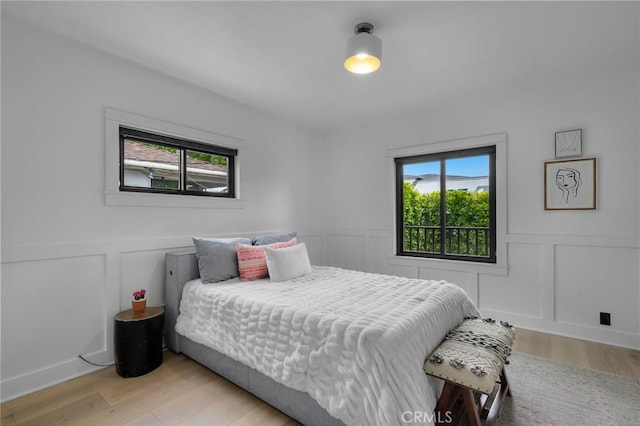 1012 10th St, Manhattan Beach, CA 90266 - bedroom with light wood-style floors, a decorative wall, and multiple windows