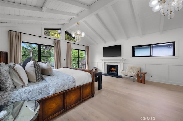 1012 10th St, Manhattan Beach, CA 90266 - bedroom featuring a warm lit fireplace, a chandelier, vaulted ceiling with beams, and light wood-type flooring