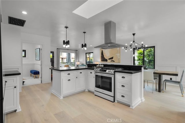 1012 10th St, Manhattan Beach, CA 90266 - kitchen featuring island exhaust hood, stainless steel gas stove, a chandelier, and dark countertops