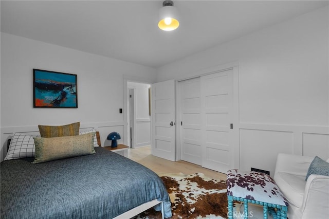 1012 10th St, Manhattan Beach, CA 90266 - bedroom with a closet, a wainscoted wall, a decorative wall, and light wood-type flooring
