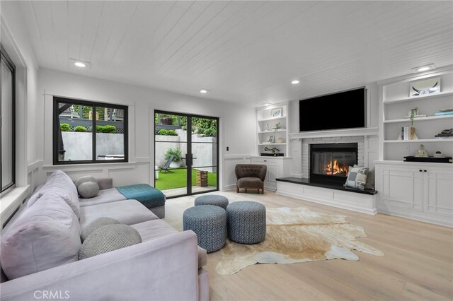 1012 10th St, Manhattan Beach, CA 90266 - living room featuring recessed lighting, a glass covered fireplace, wood finished floors, and built in shelves
