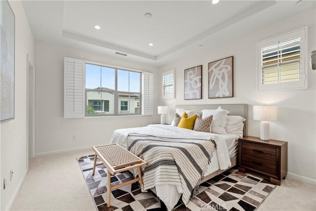 bedroom with recessed lighting, carpet flooring, baseboards, visible vents, and a raised ceiling